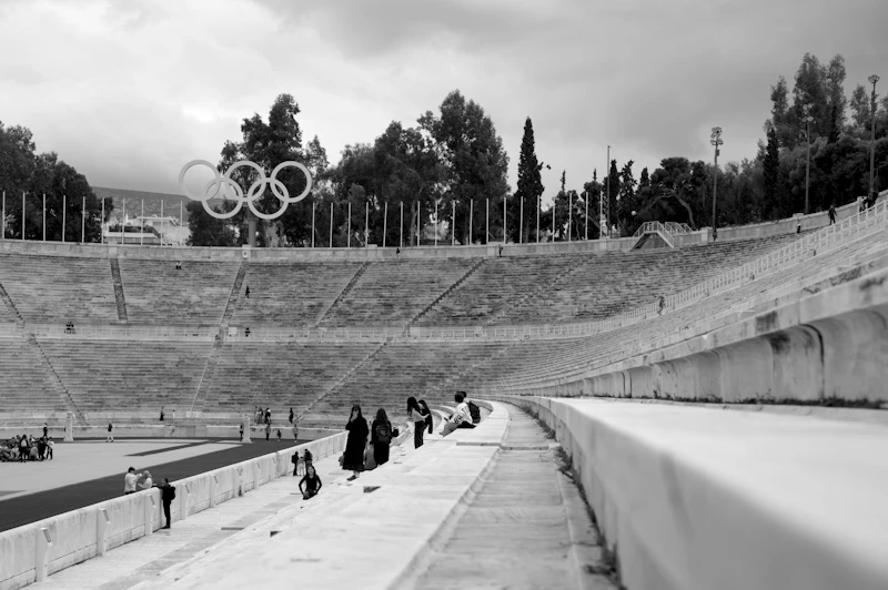 Olympic-style stadium with athletes blurred in motion