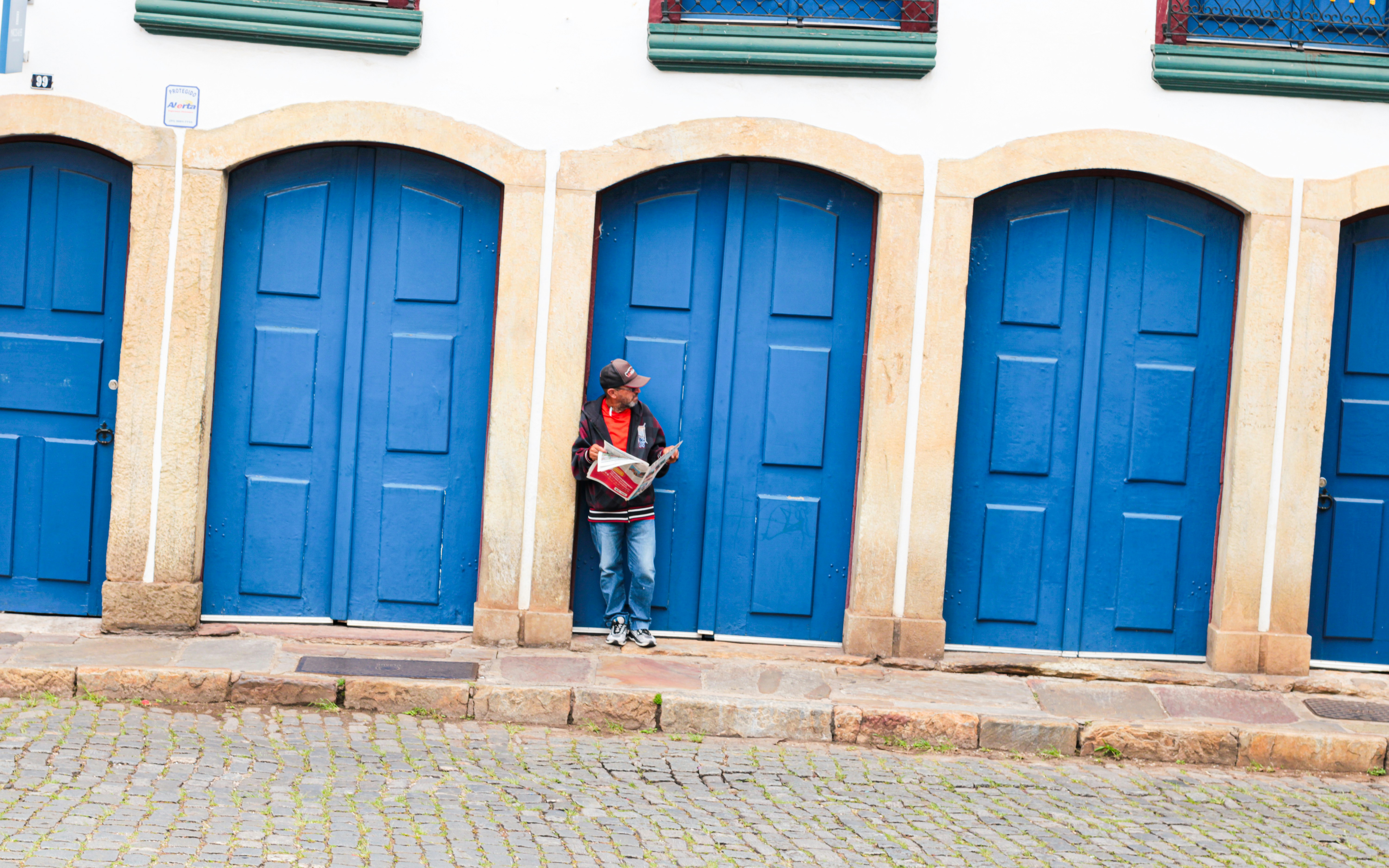 Person standing in front of bright blue doors