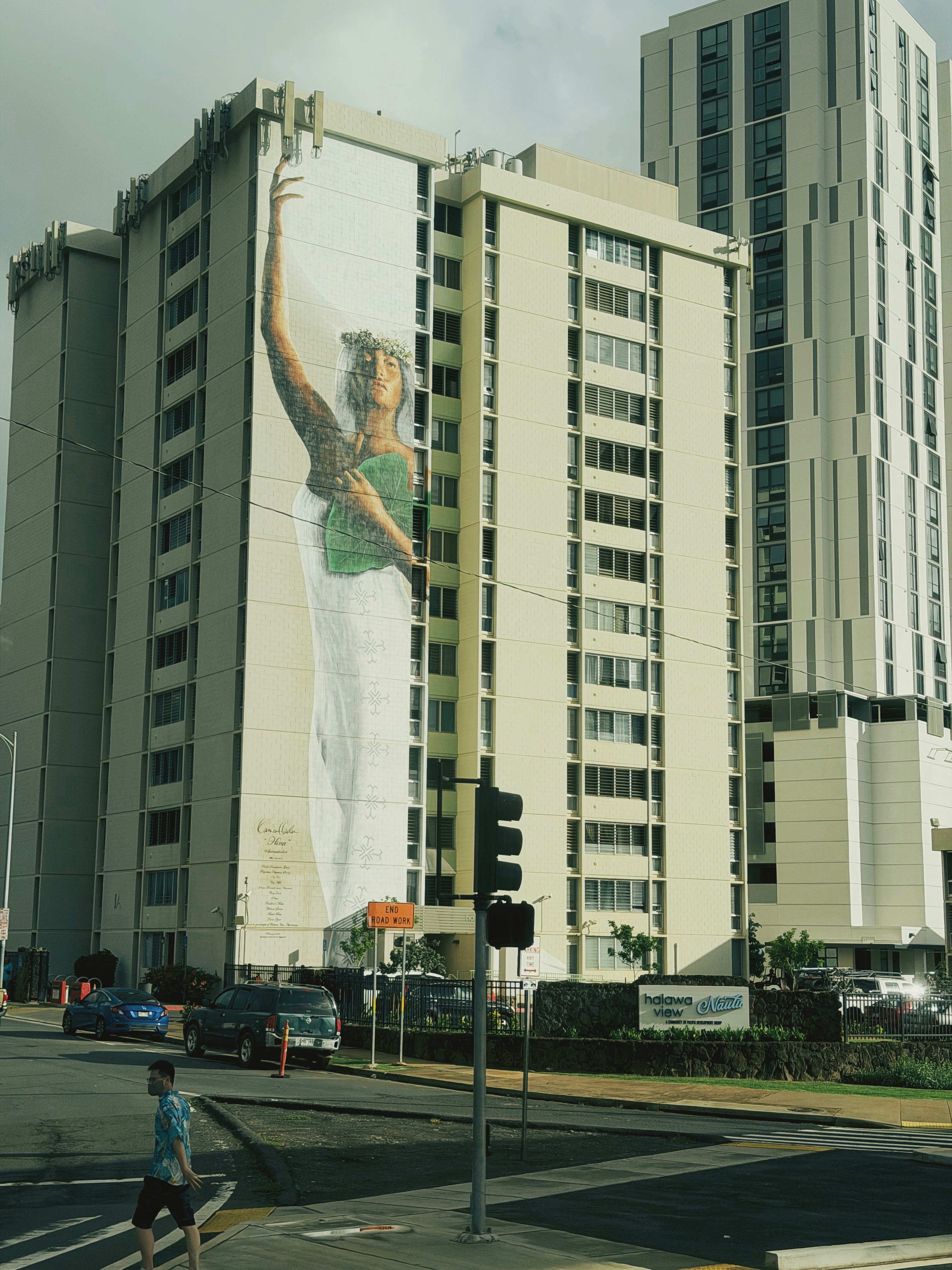 Mural of a woman on a tall building.