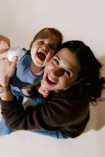 Mother and baby laughing together joyfully