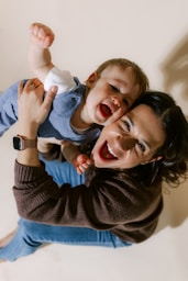 Mother holding her laughing baby son