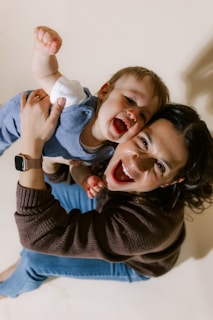 Mother holding her laughing baby son