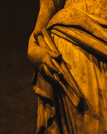 Marble statue of a draped figure holding a scroll