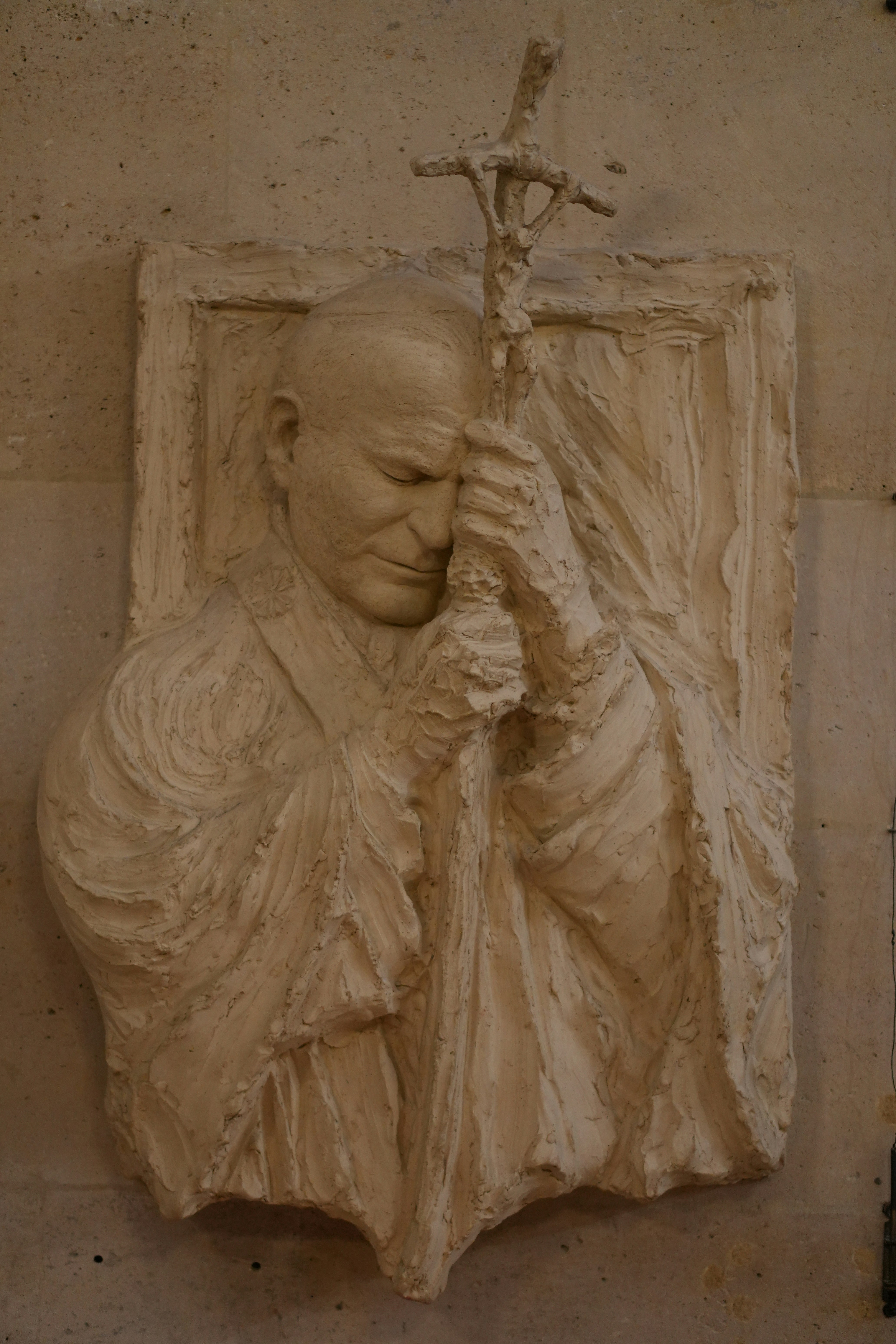 Relief sculpture of pope john paul ii praying