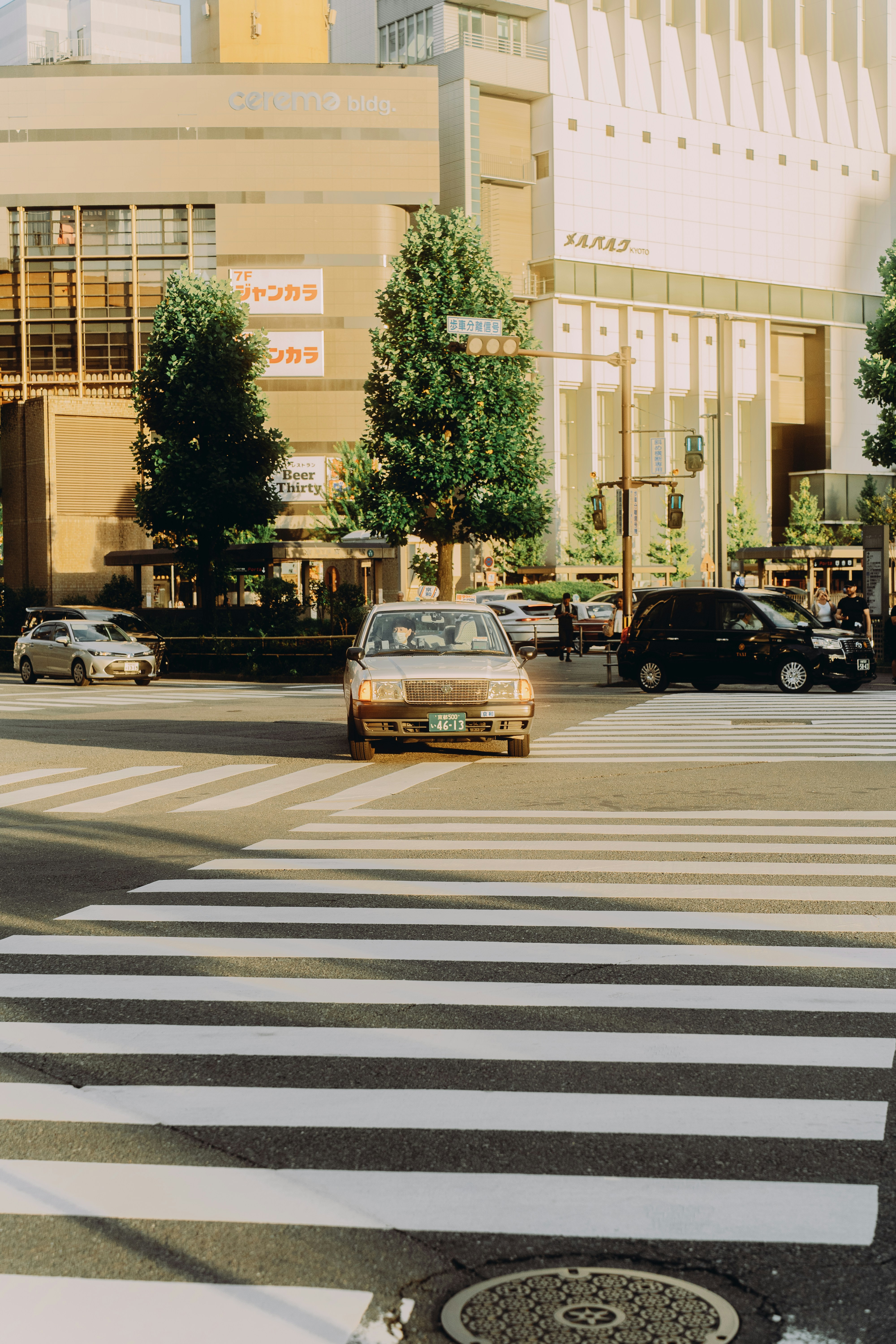 Cars at a busy city intersection with crosswalk.