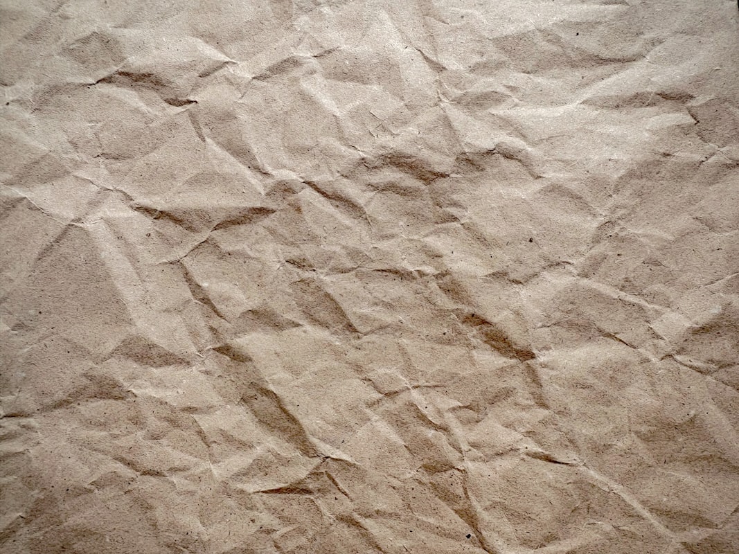 Crinkled brown kraft paper texture used as wrapping material for rigid boxes