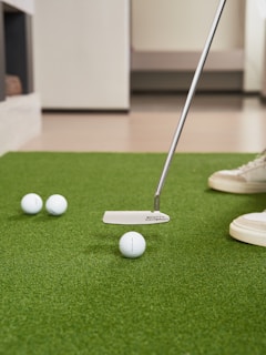 Putting golf balls on a green carpet indoors