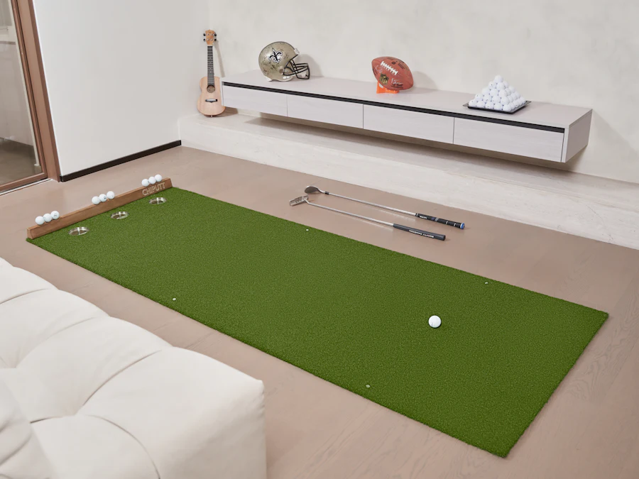 Indoor putting green with putter and ball