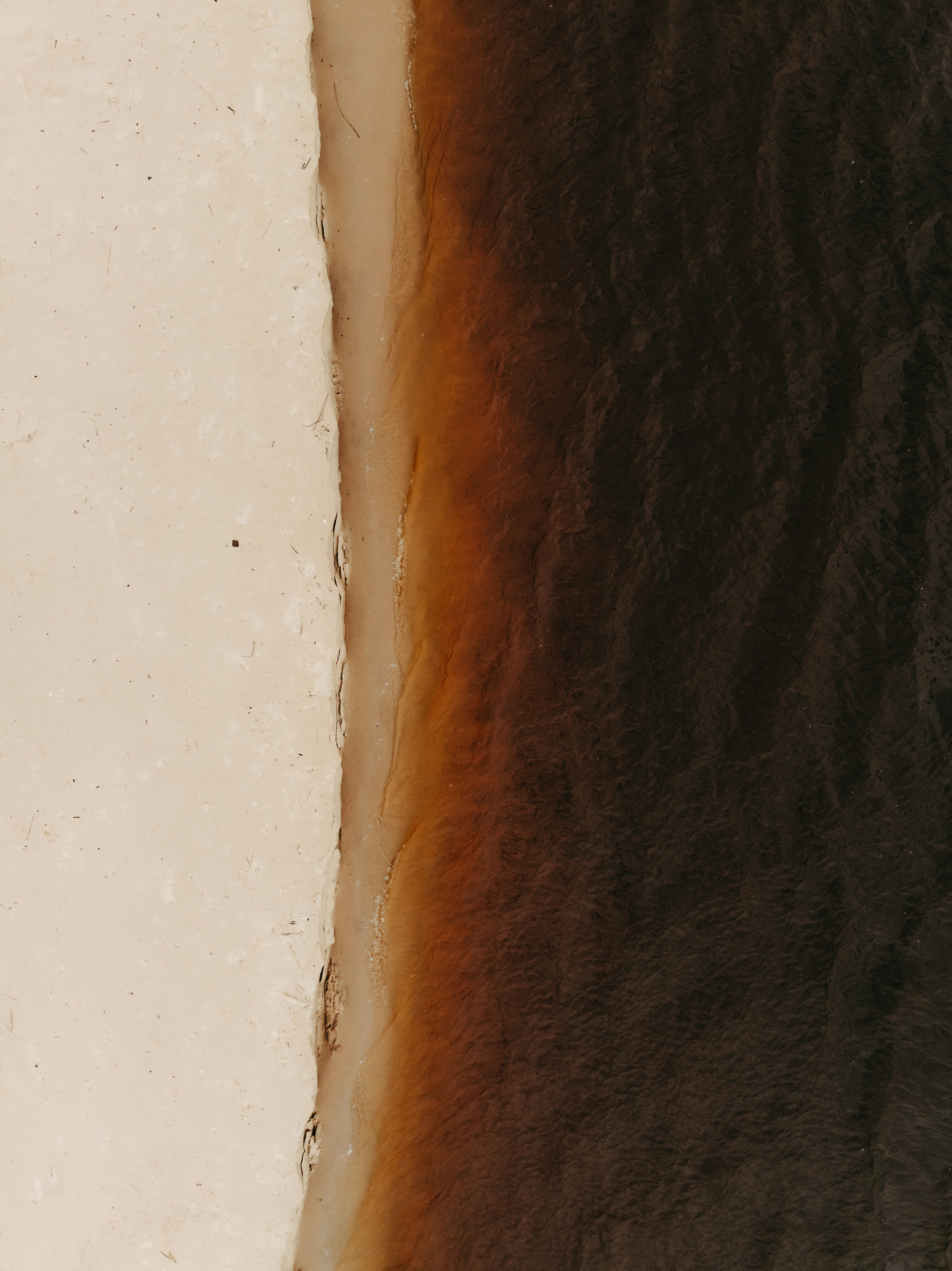 Abstract view of land meeting dark water