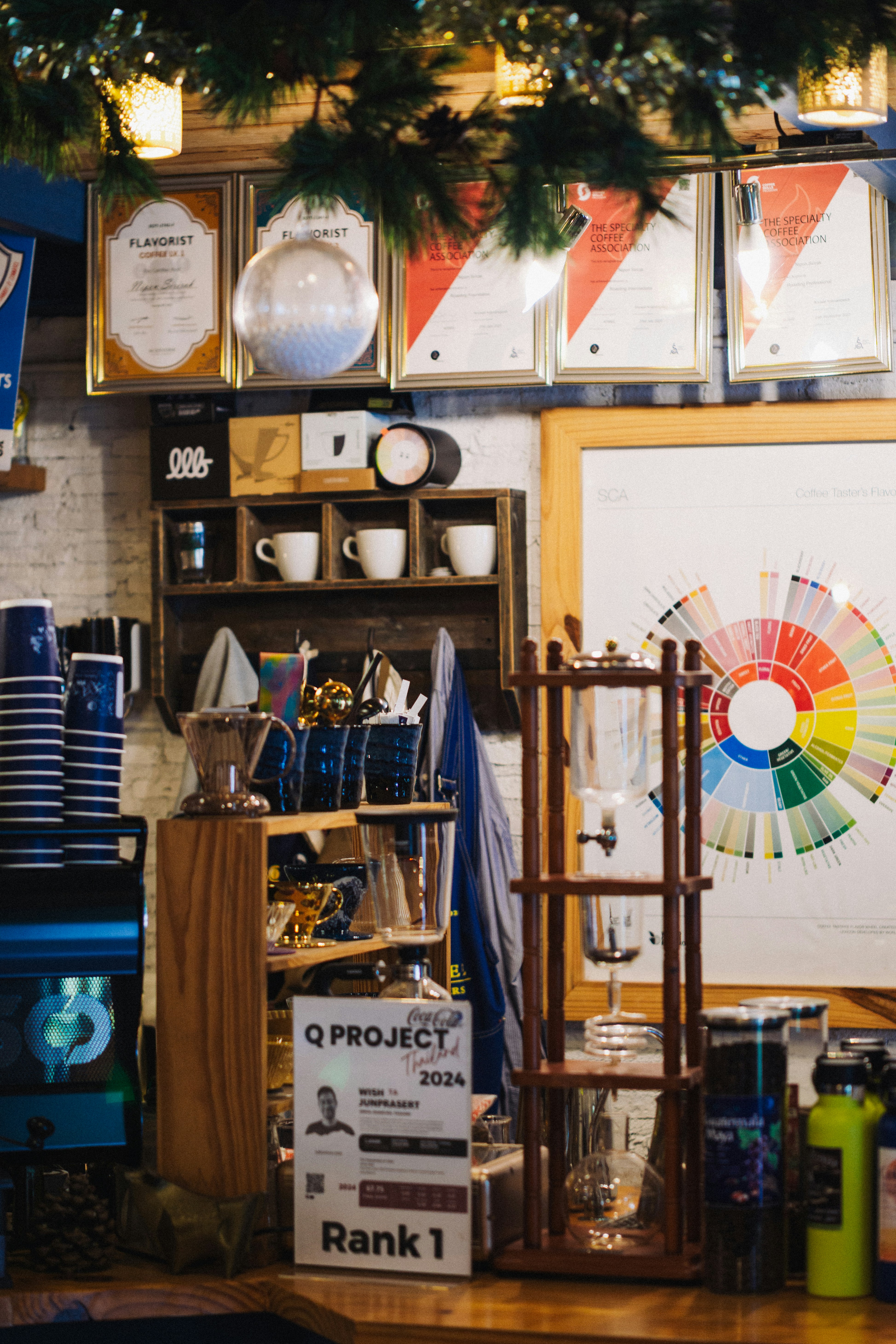 Coffee shop counter with brewing equipment and awards.