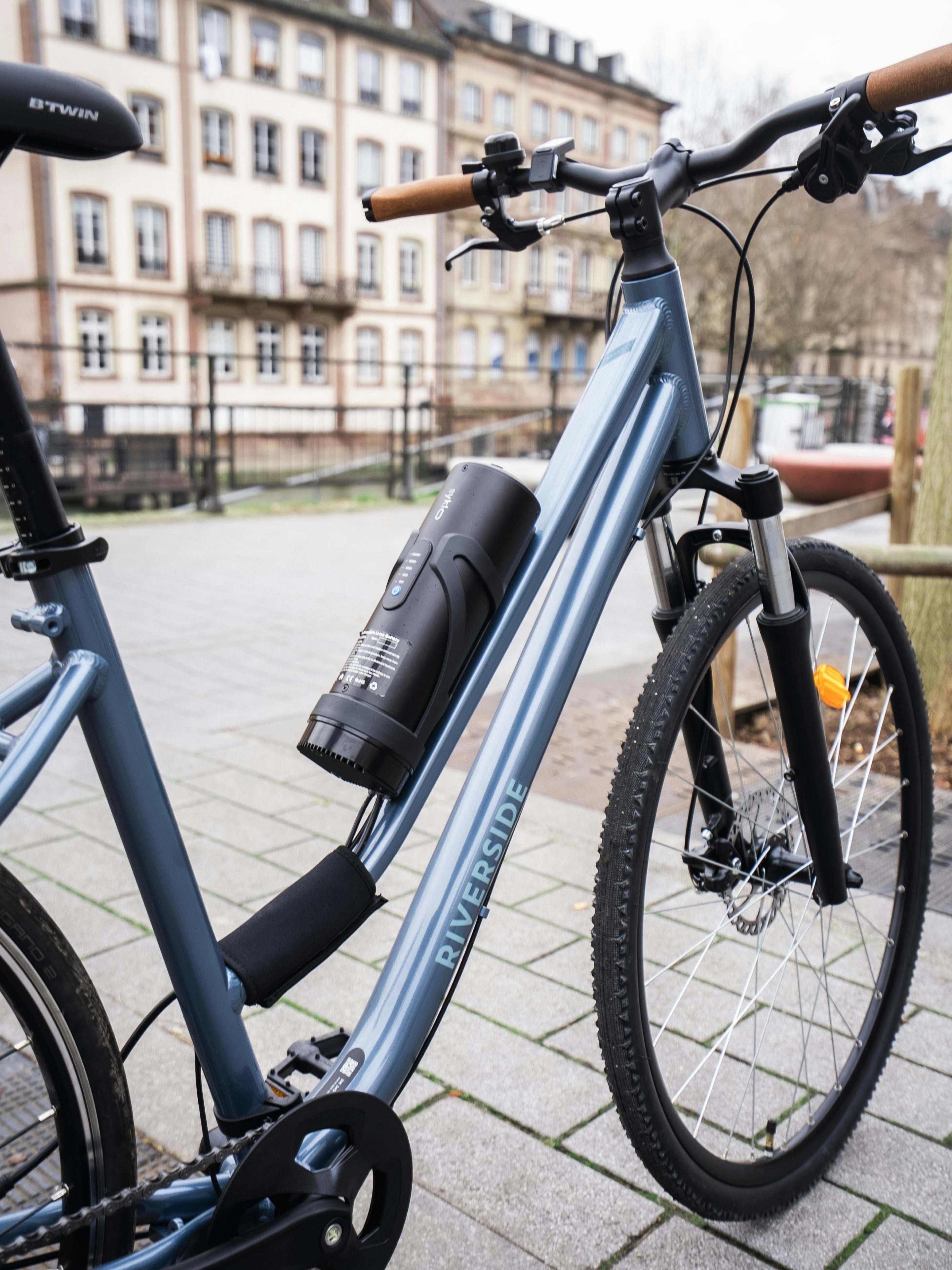 A blue bicycle with a water bottle attached.