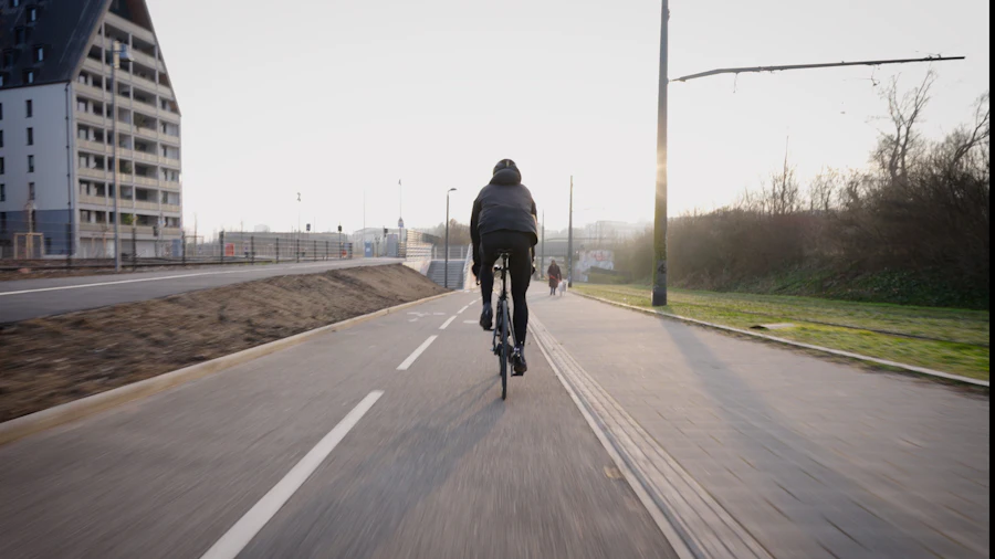 Cyclist riding a paved path at sunset