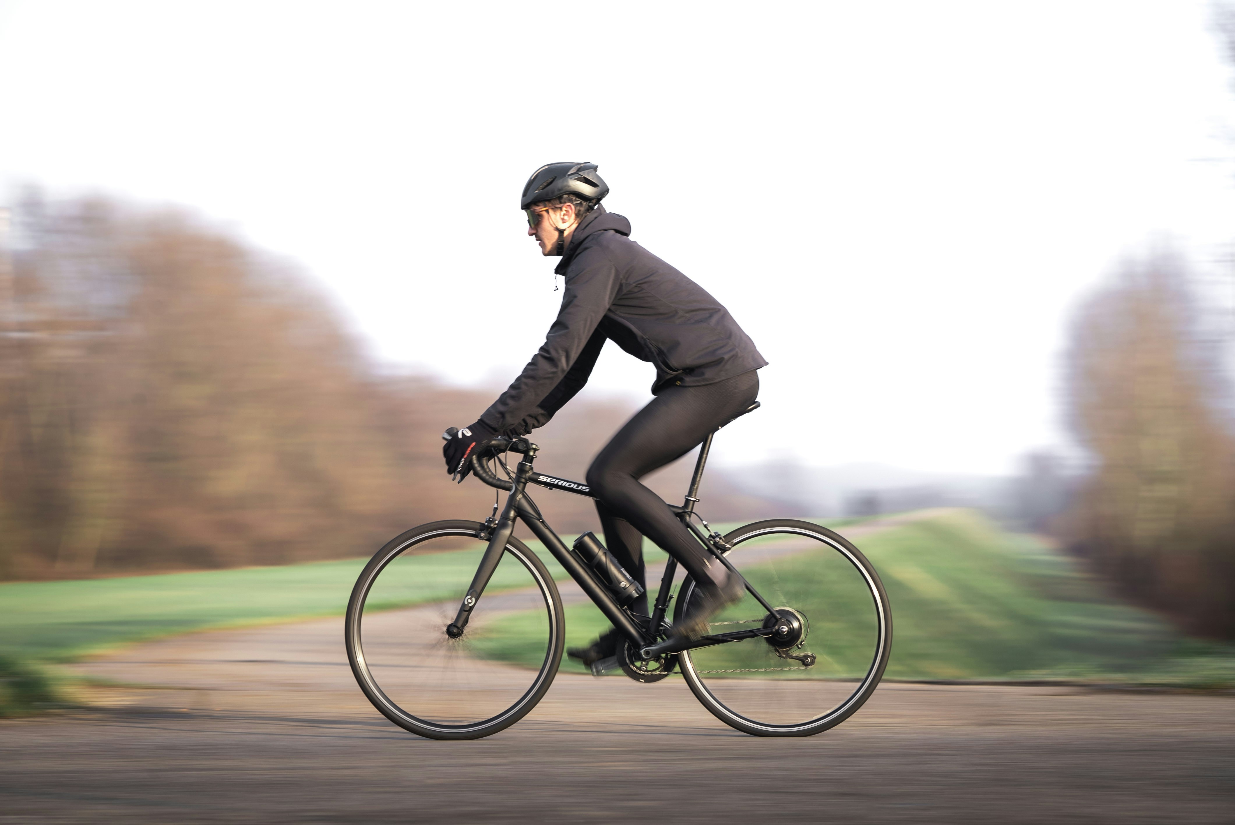 Woman cycling on a road with blurred background