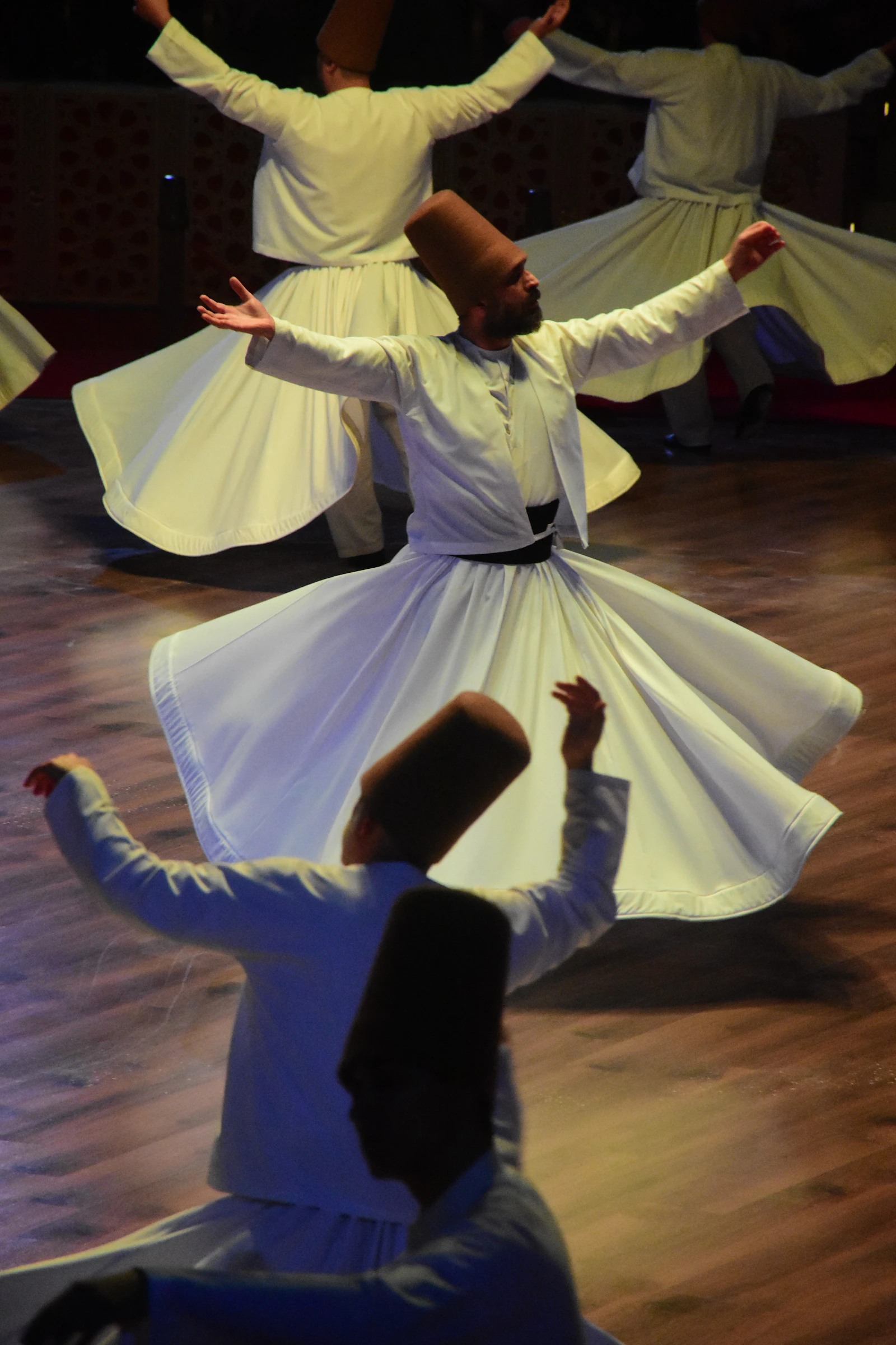 People in traditional clothing moving together in a circle, suggesting community and ceremony