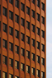 Rows of windows on an orange building facade.