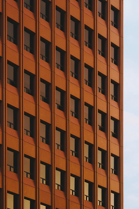 Rows of windows on an orange building facade.