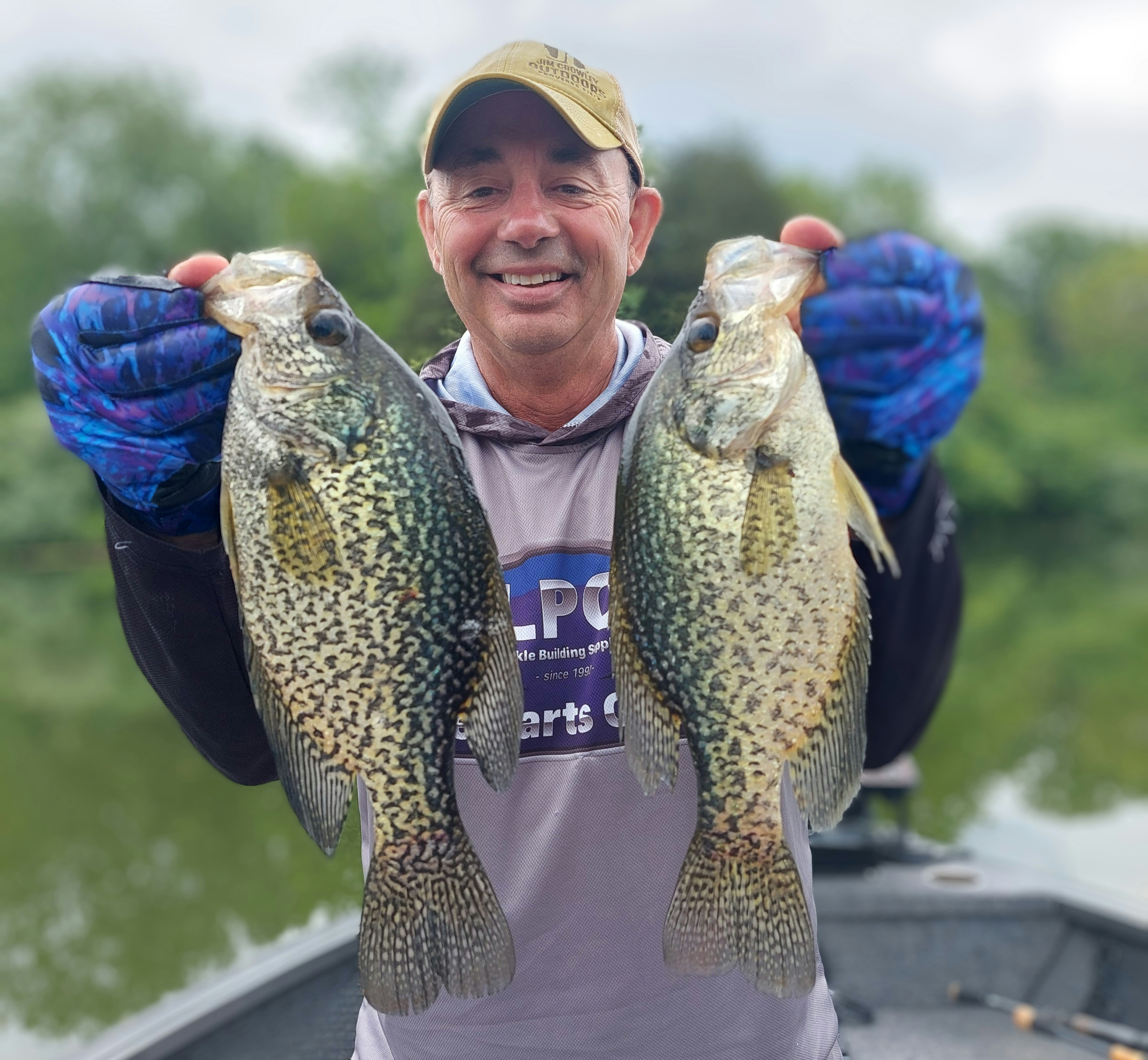 Man holding two large crappie fish