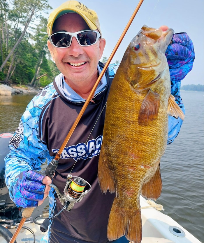 Angler holding a large smallmouth bass caught on the James River at Robious Landing