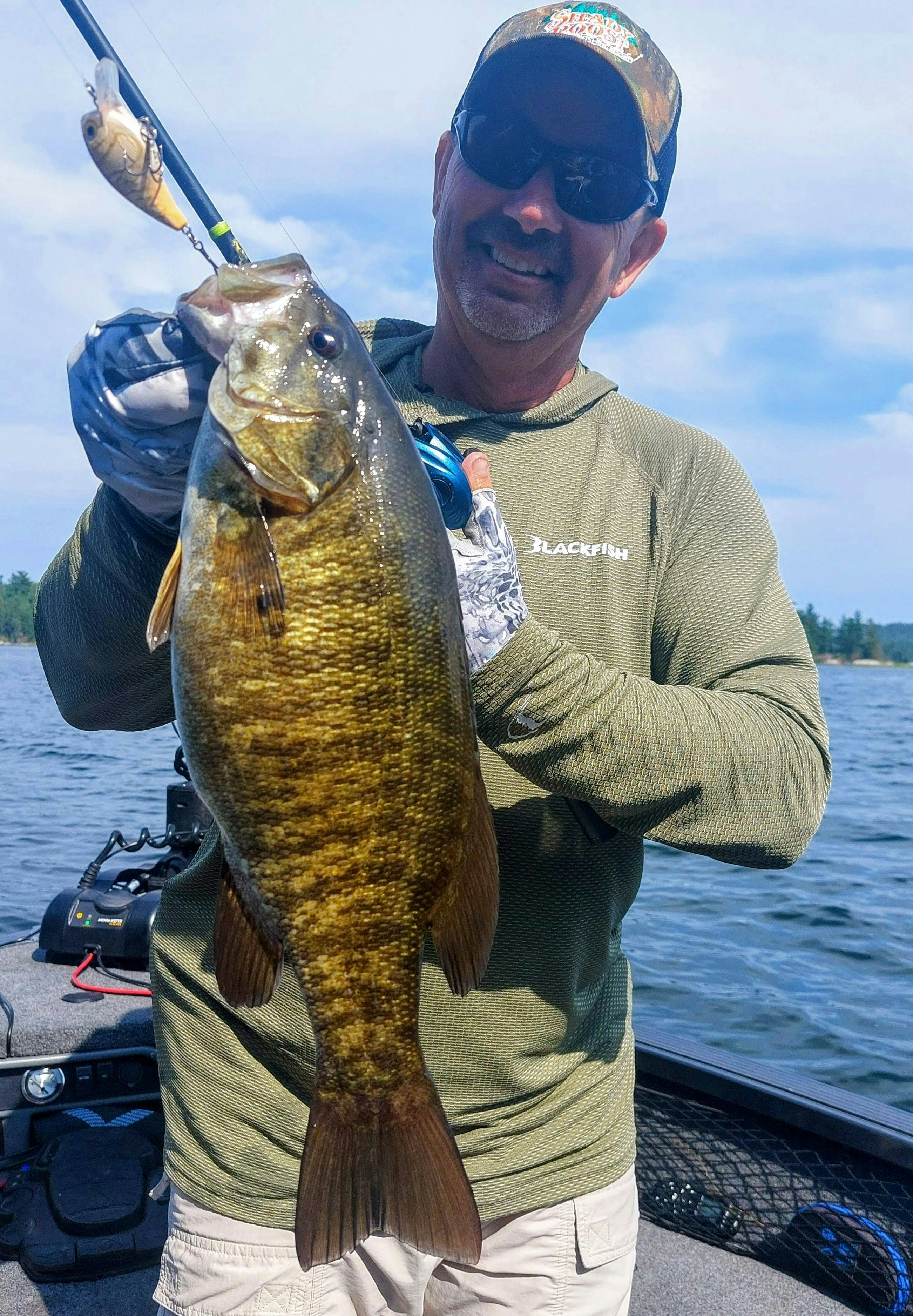 Man holding a large smallmouth bass fish