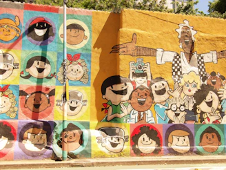Mural of cartoon faces in colorful squares.