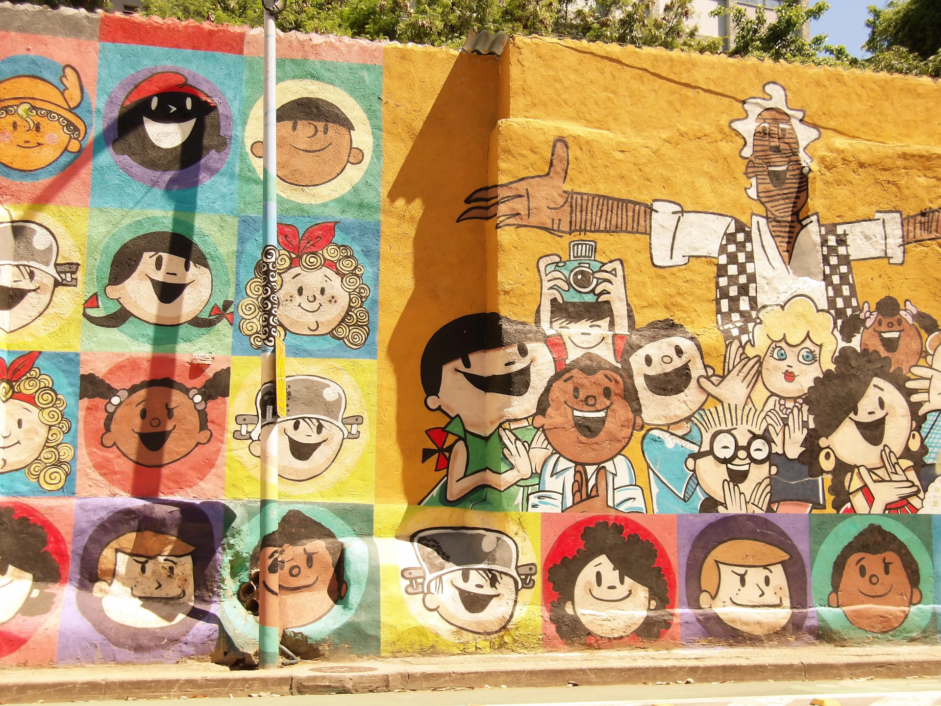 Mural of cartoon faces in colorful squares.