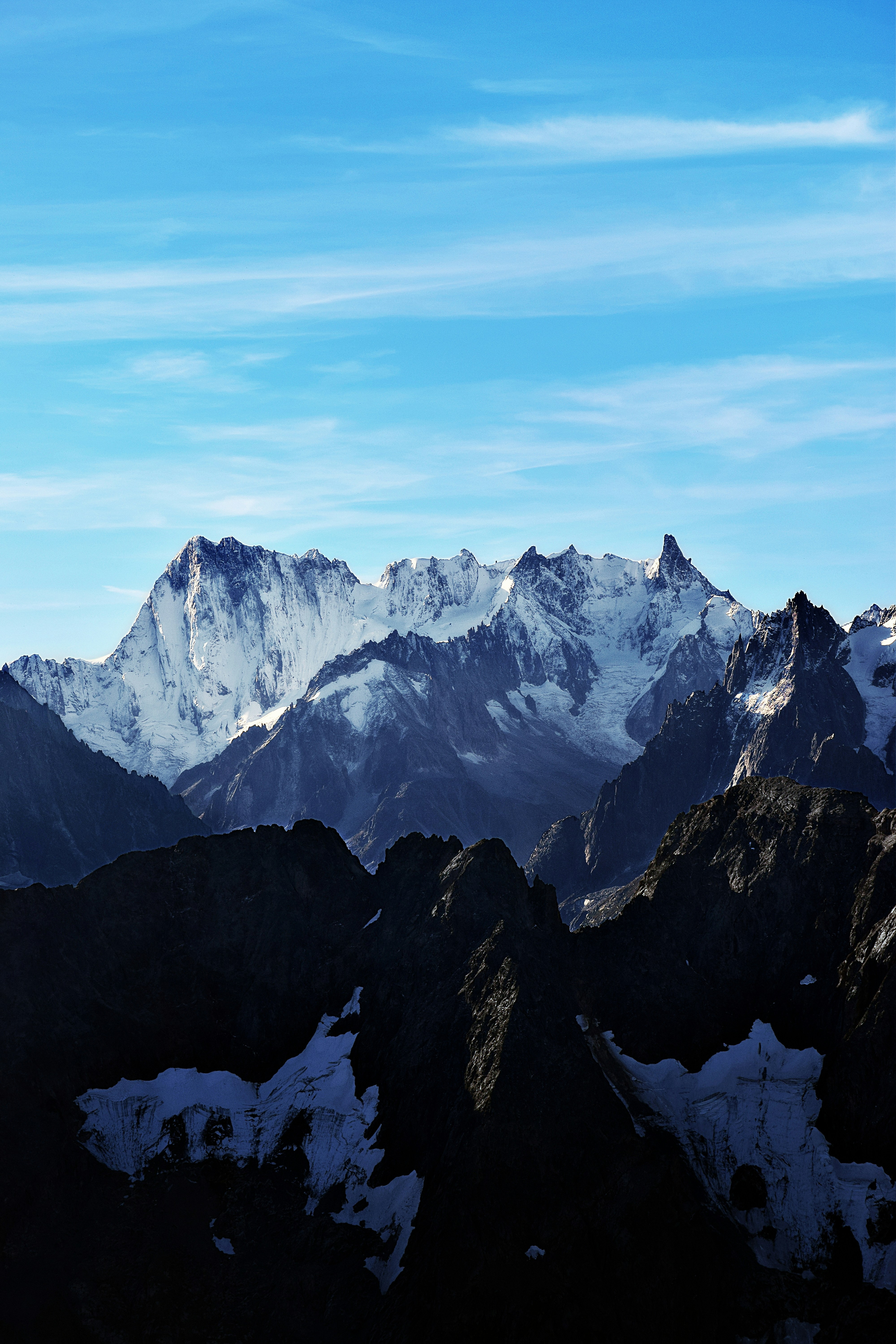 Snow-capped mountains under a bright blue sky