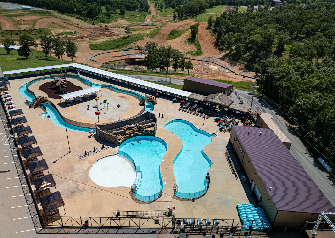 An aerial view of an outdoor waterpark with pools and slides