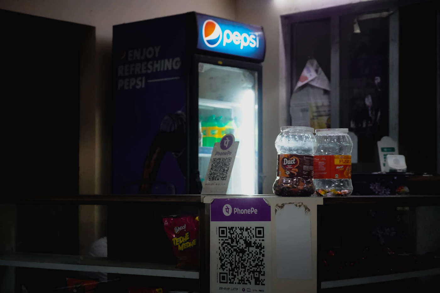 QR code payment sticker on a drinks cooler in a shop