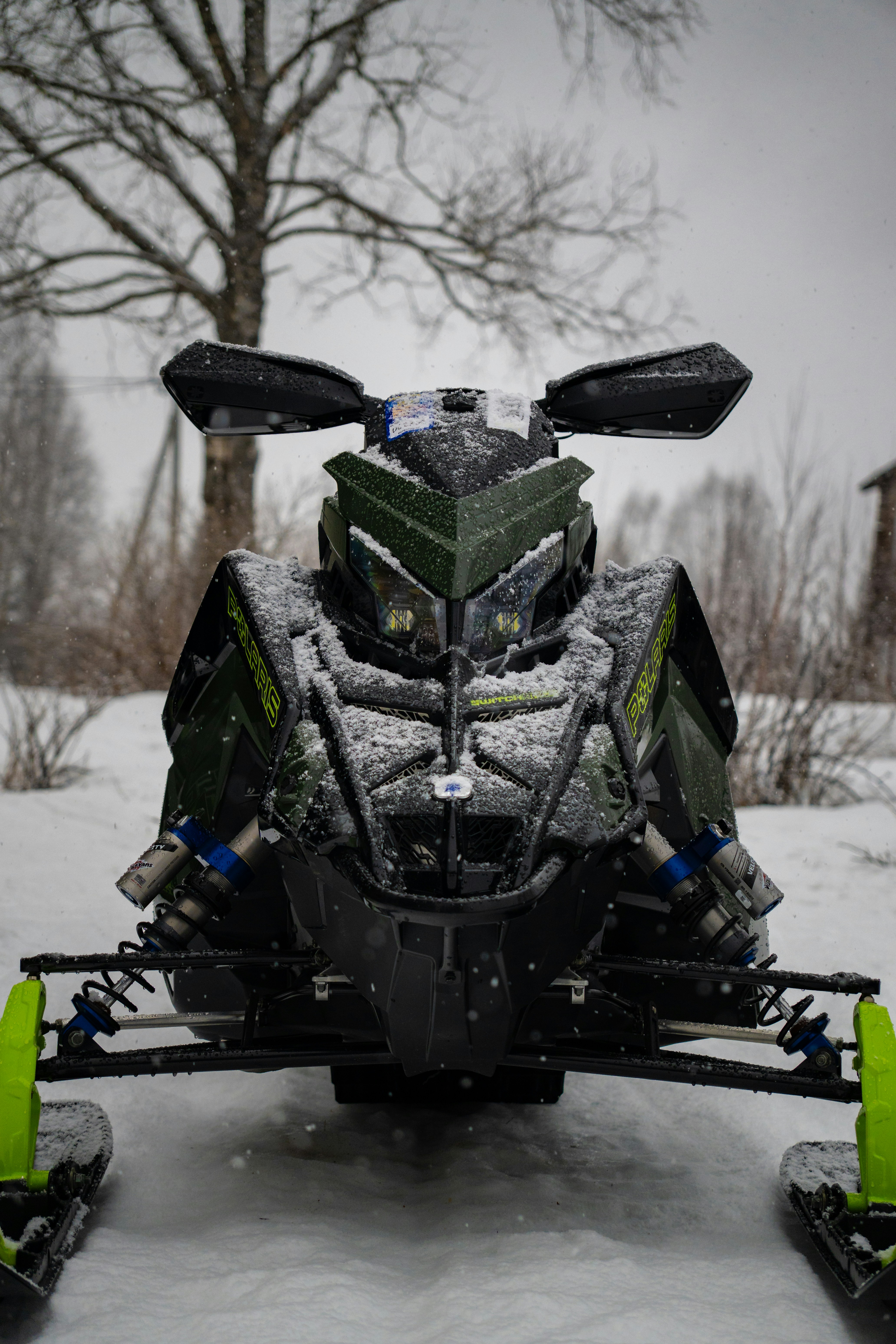 A snowmobile covered in snow outdoors