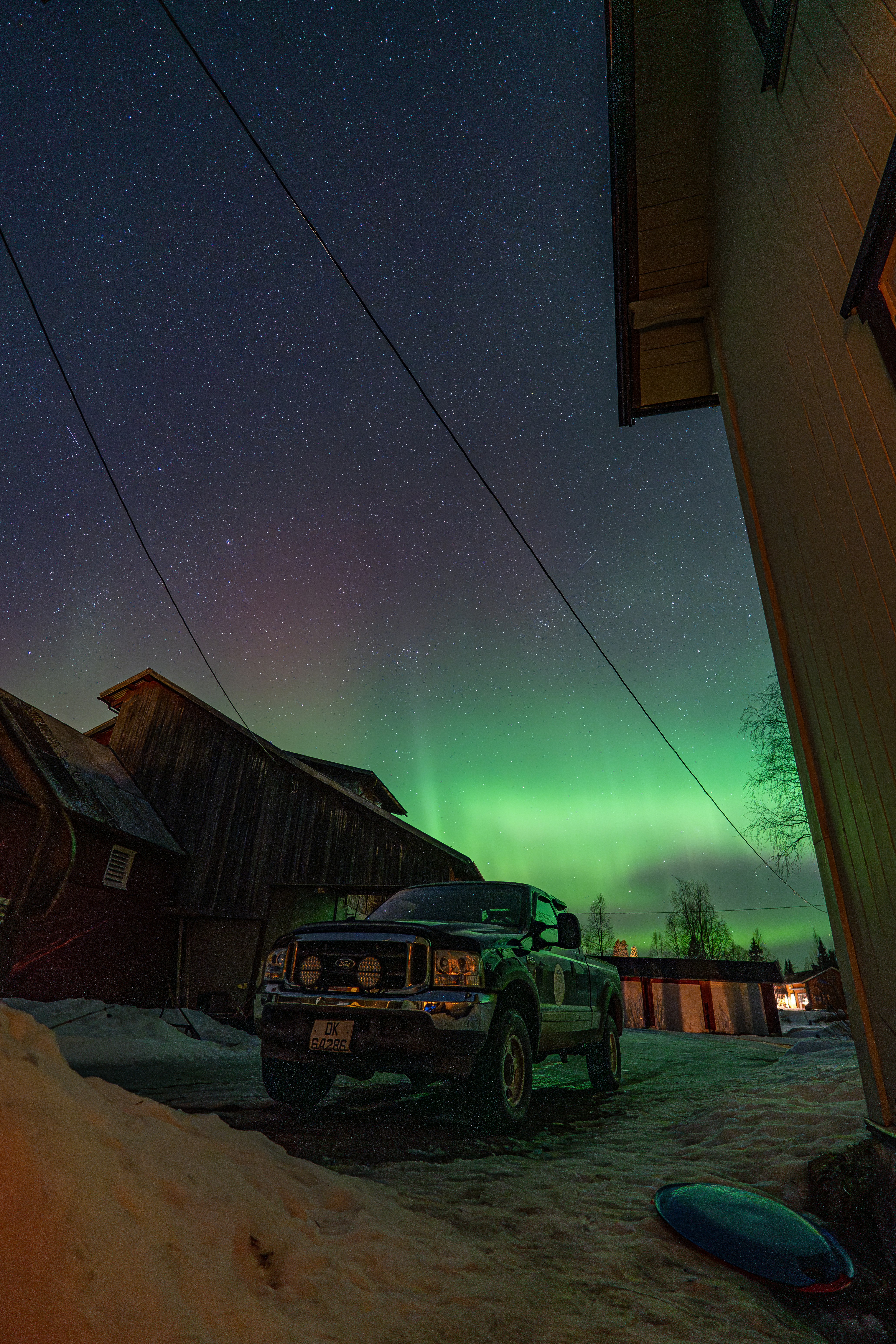 Truck under the aurora borealis at night.