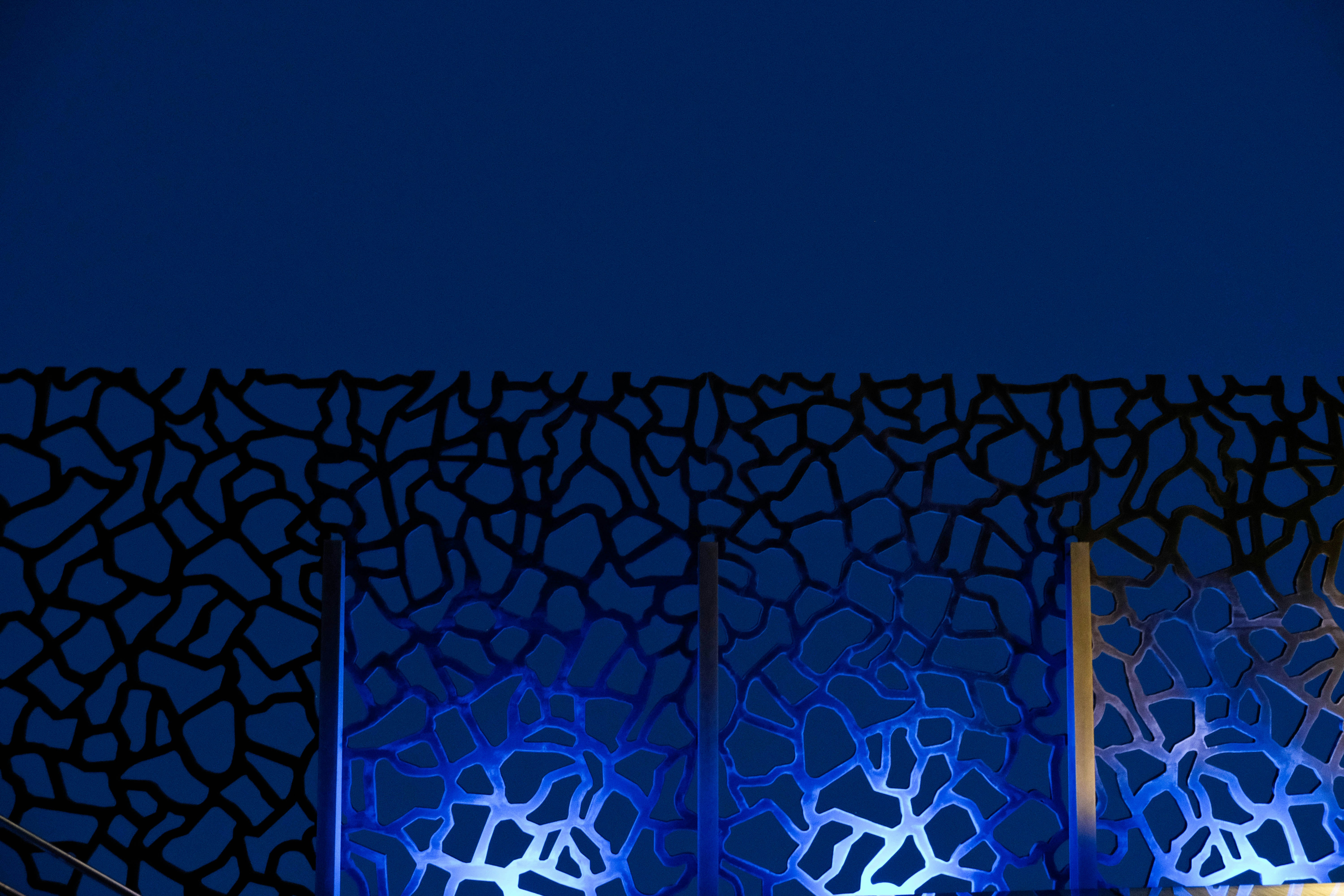 Dark blue wall with abstract pattern and lights