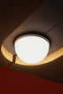 A modern ceiling light fixture with warm ambient lighting.