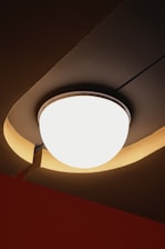 A modern ceiling light fixture with warm ambient lighting.