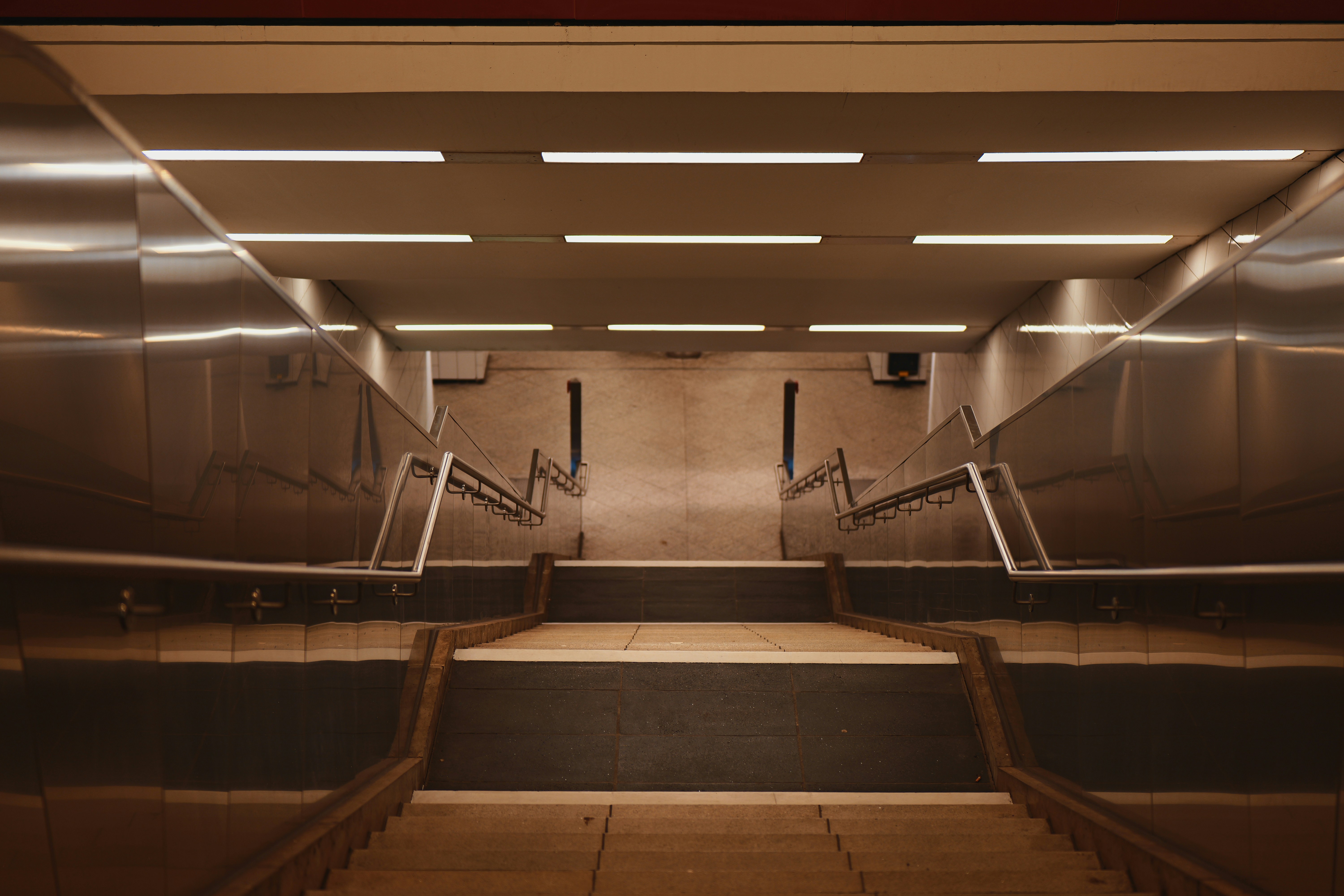 A modern subway station staircase with bright lights. - a-modern-subway-station-staircase-with-bright-lights-PJ_Y1rQ03rY