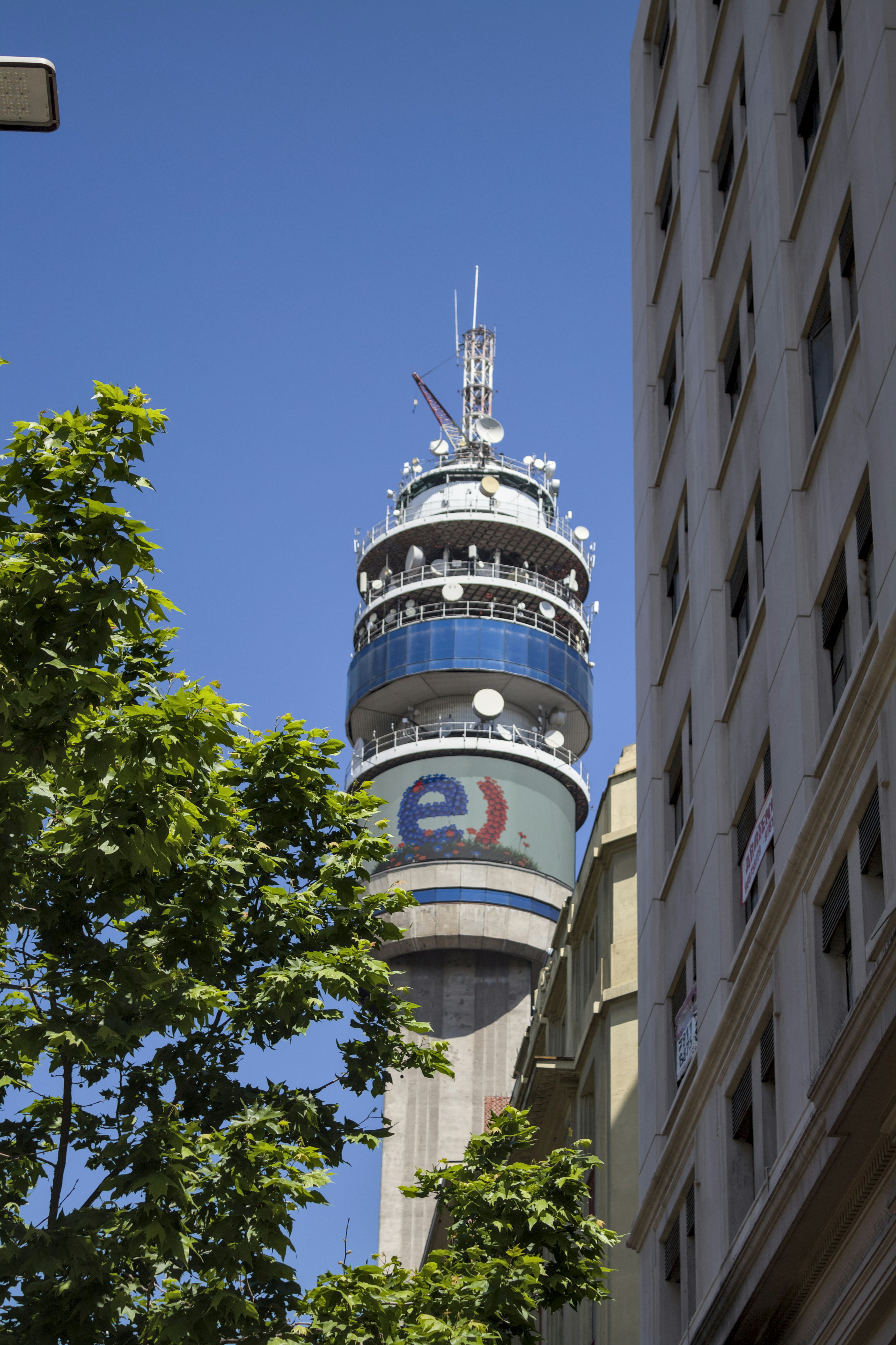 A tall tower with blue accents and a logo.