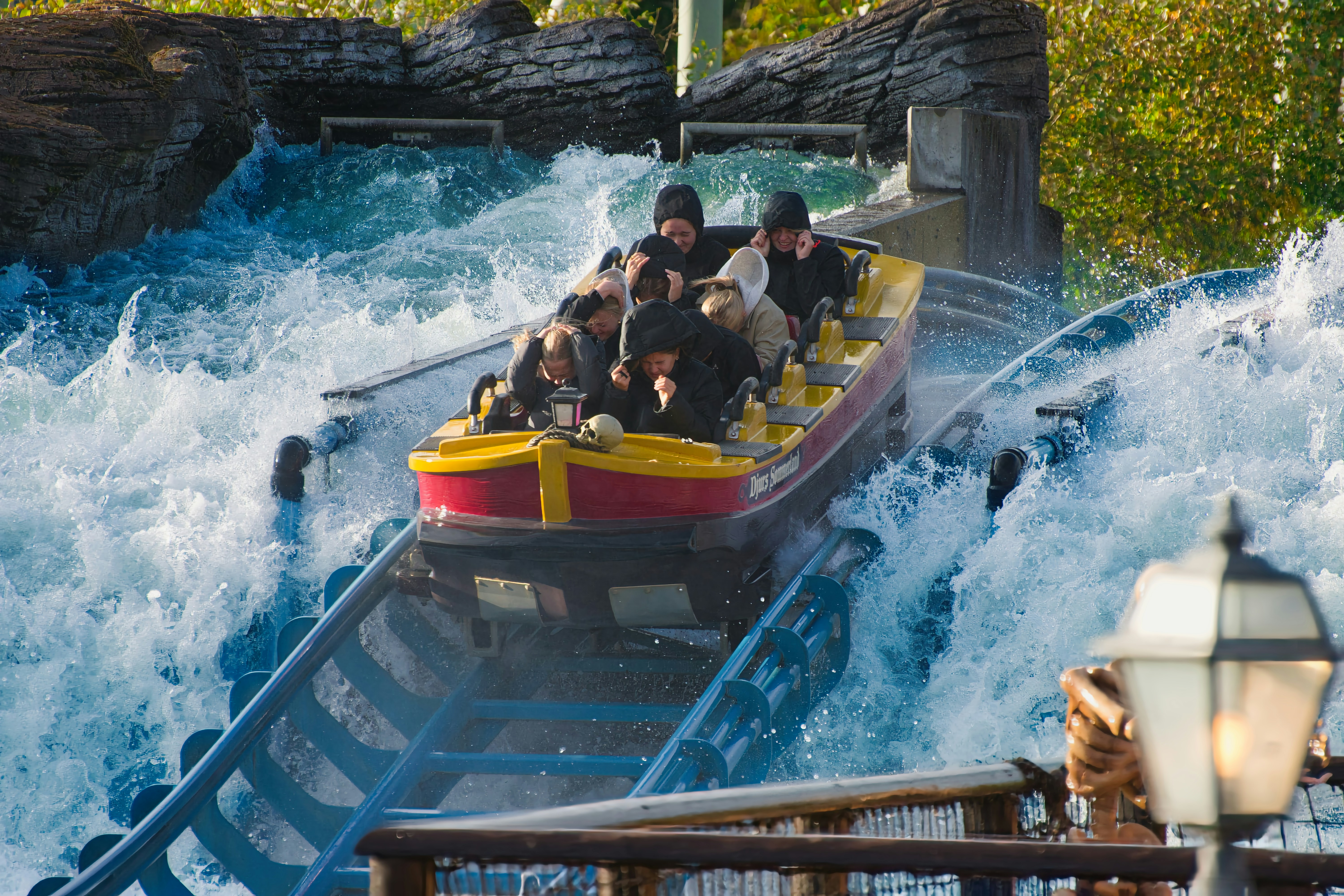 People on a thrilling water ride splashing water