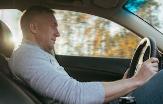 Man driving a car on a sunny day