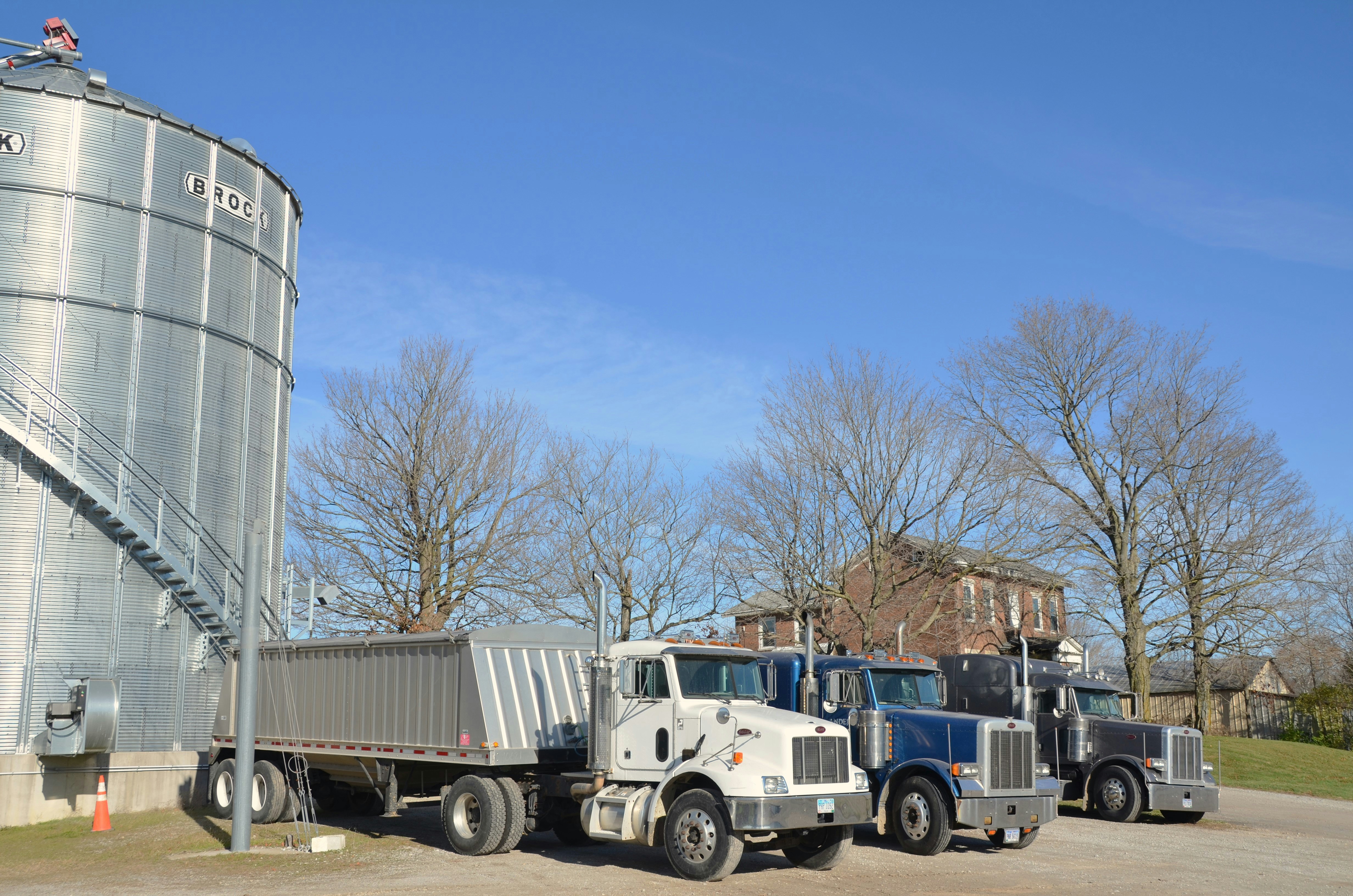 Semi-trucks near grain silo