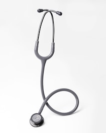 A gray stethoscope on a white background
