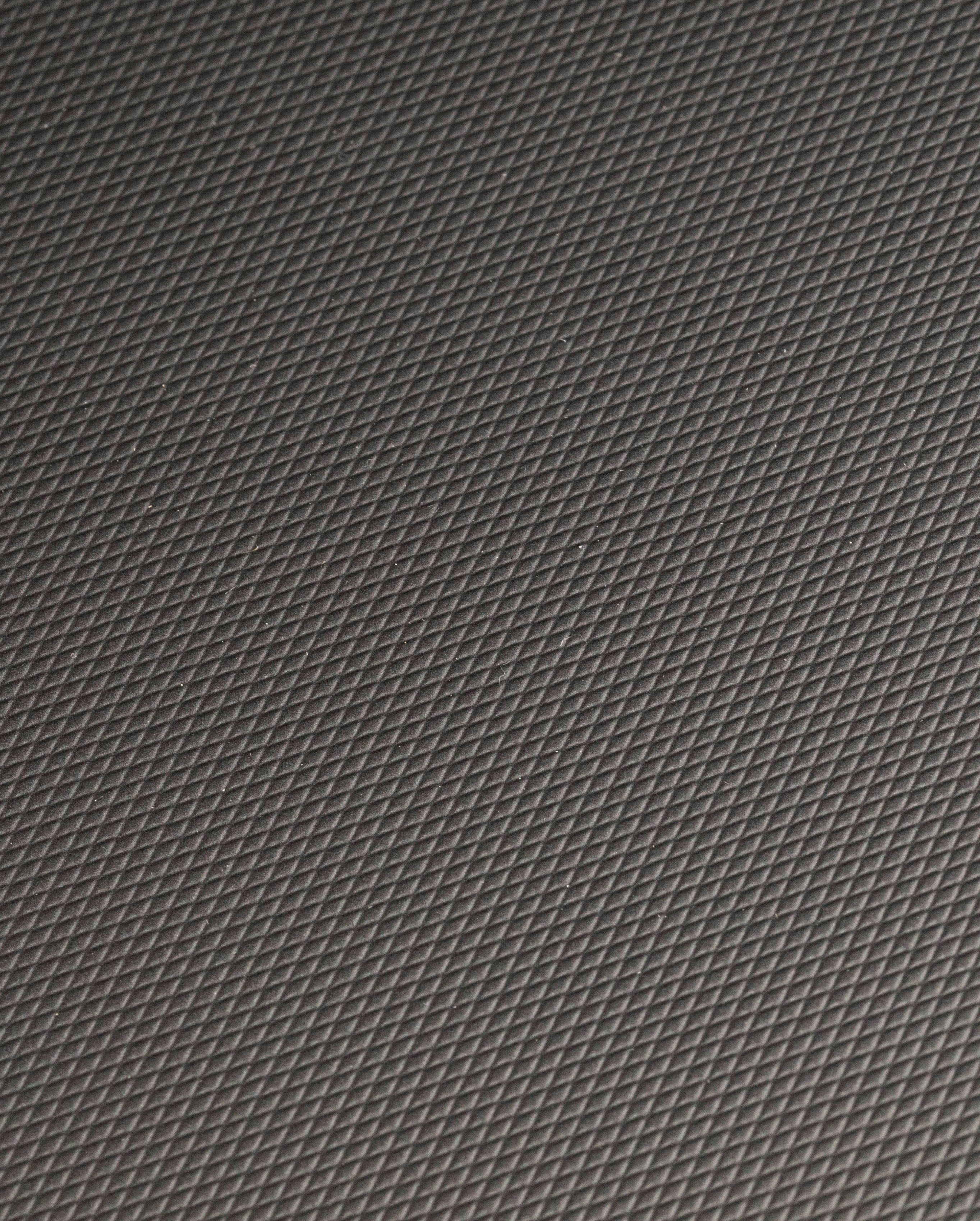 Textured dark gray surface with repeating geometric pattern