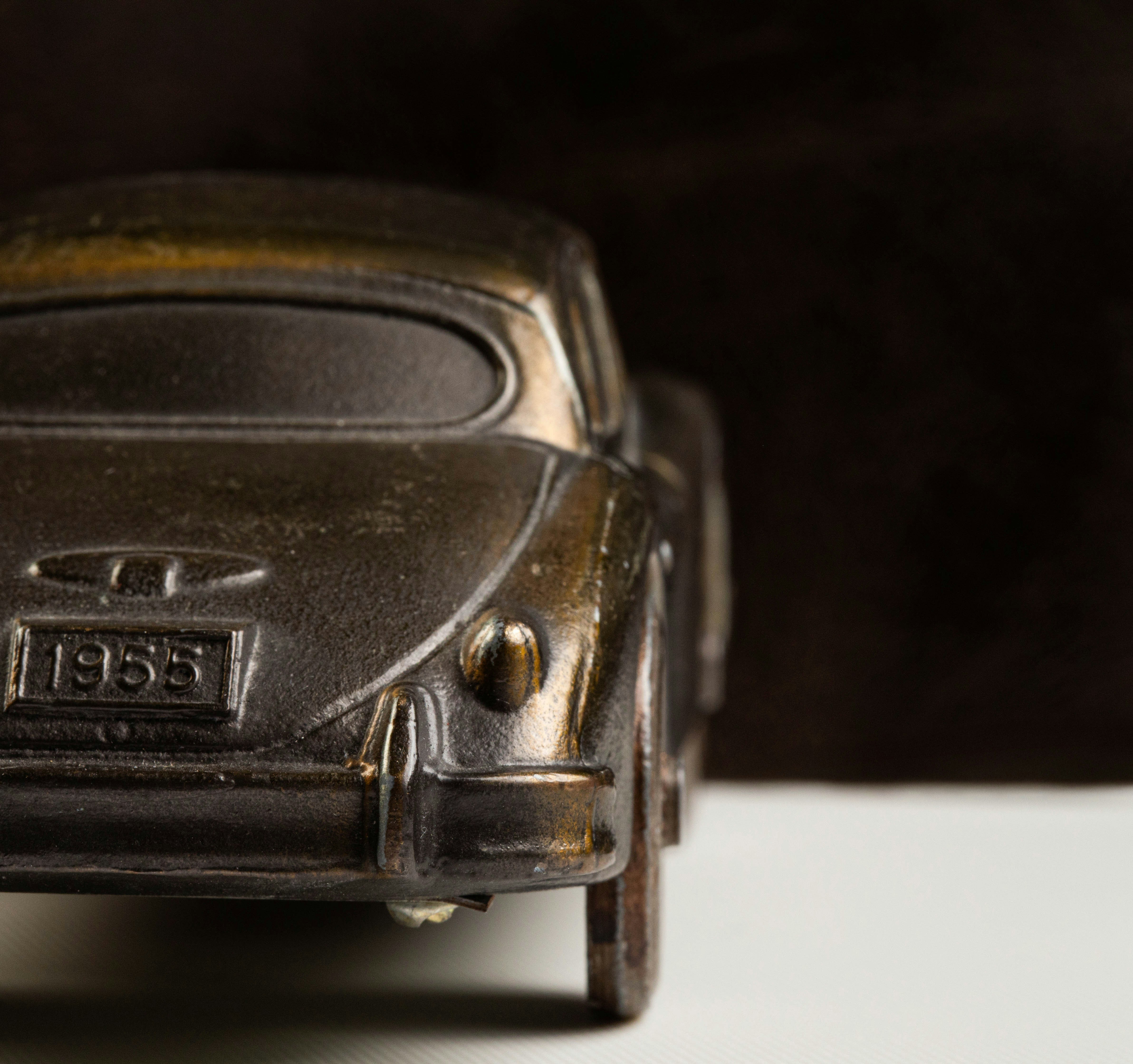 A vintage metal car model with the year 1955.