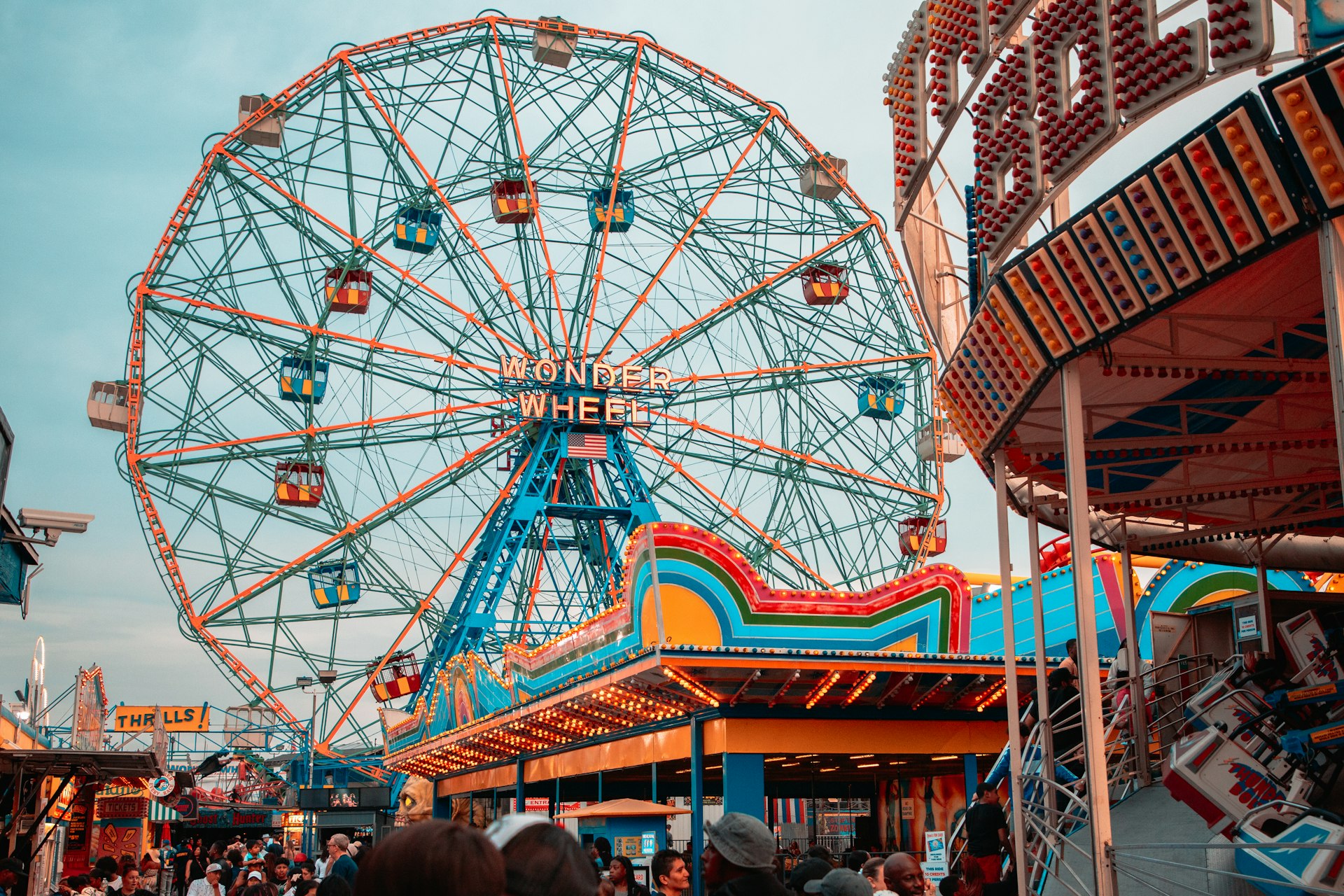 Ferris wheel and amusement park rides at dusk
