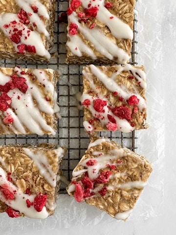 Oatmeal bars with white icing and dried raspberries