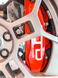 Close-up of a red carbon ceramic brake caliper.