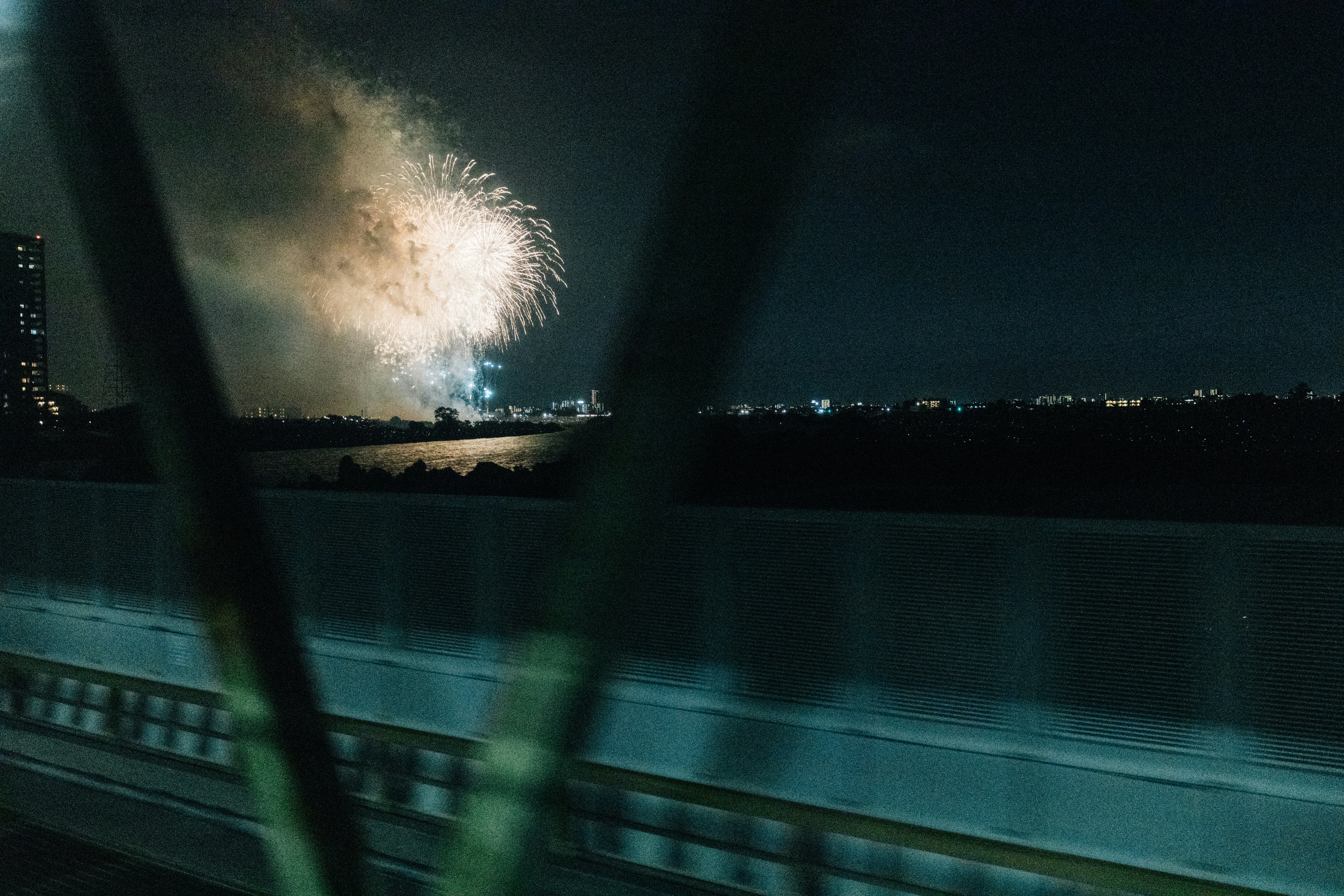 Fireworks over a river during a summer festival in Japan