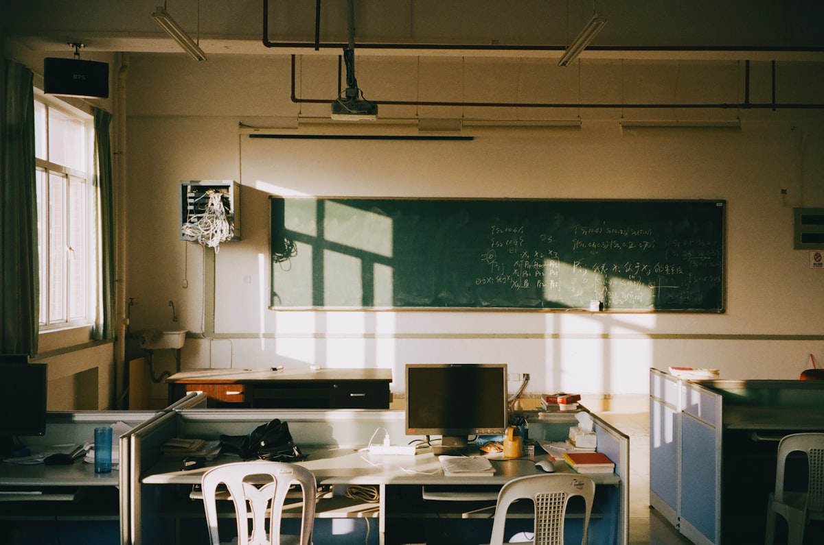 Empty classroom where a teacher applies AI rubric generators to assess student assignments