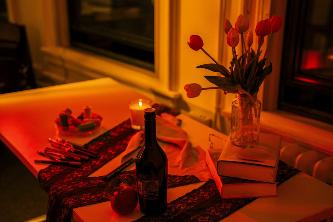 Table setting with wine, flowers, and candle