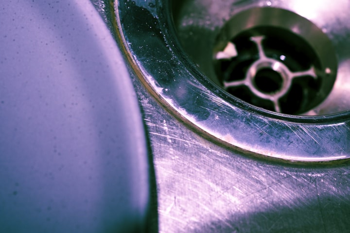 Close up of a stainless steel sink drain