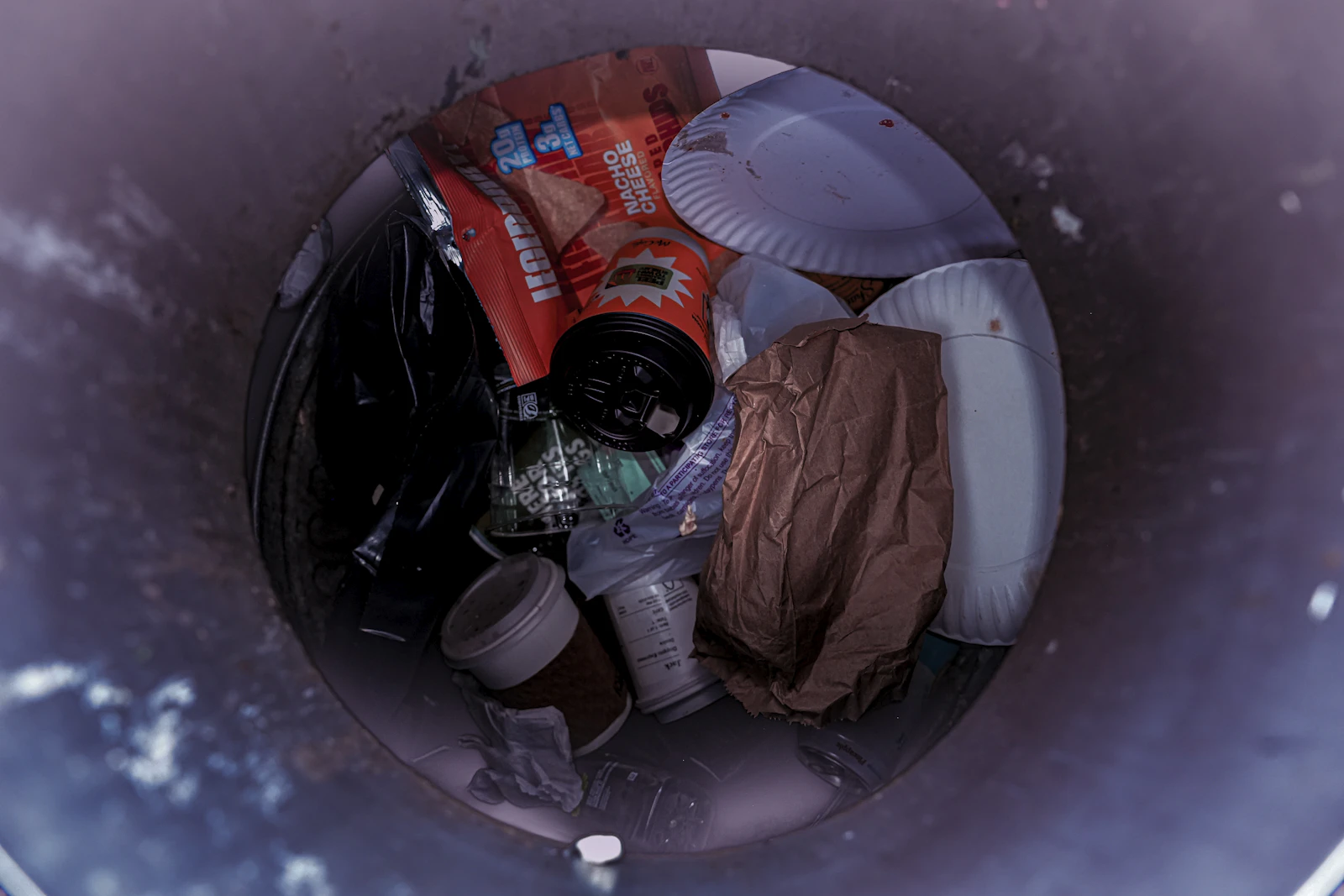 A trash can filled with various discarded items