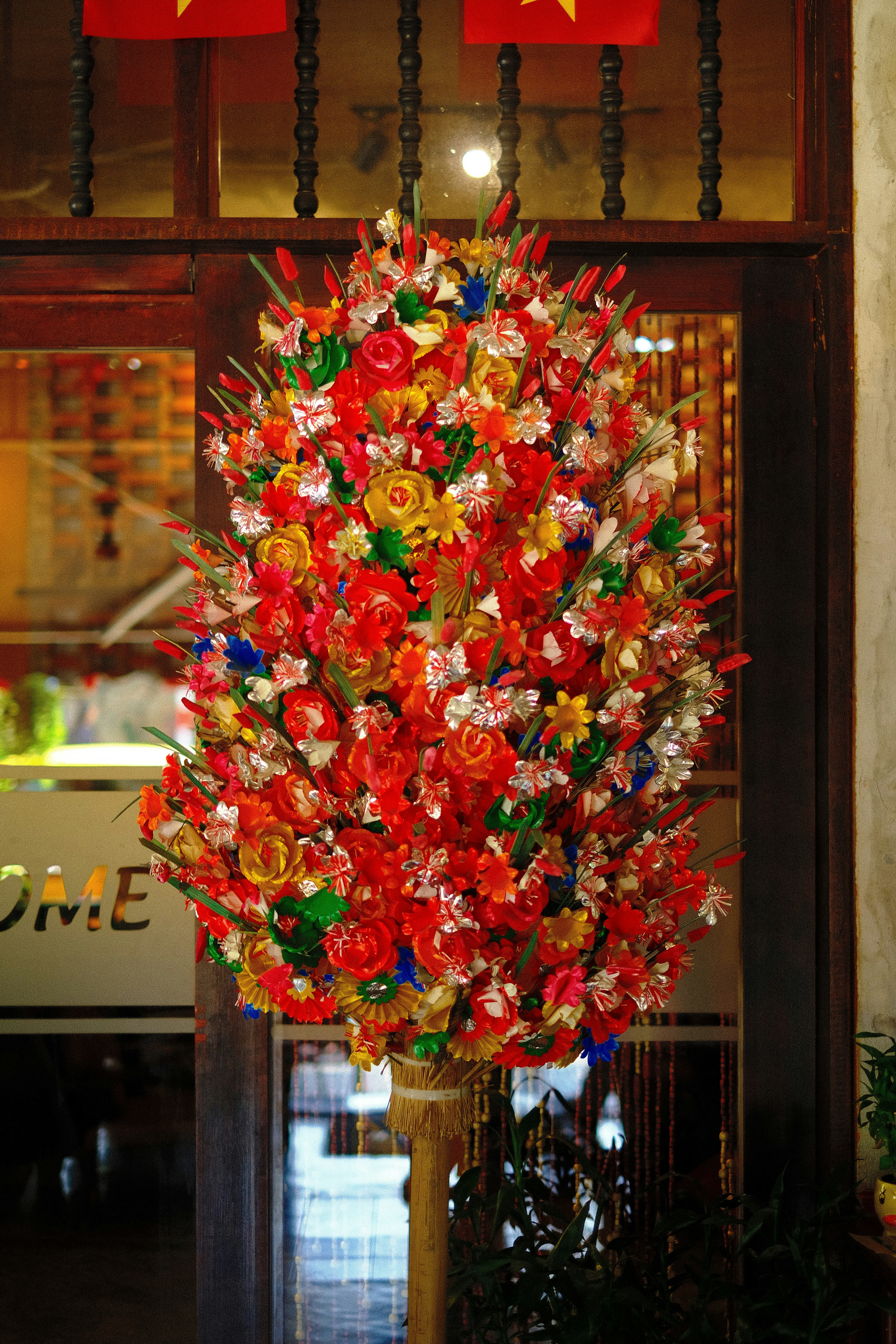 A large, colorful floral arrangement with red flowers.
